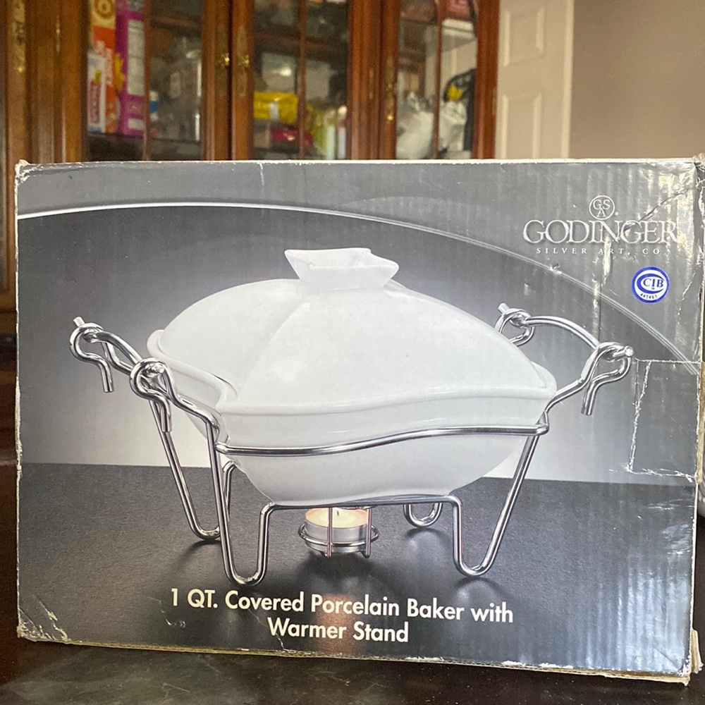 1 qt Covered Porcelain baker with warmer stand still in box. Never used